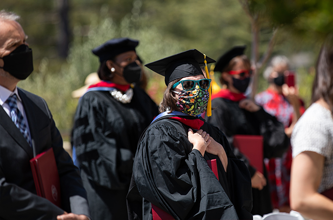 Students from the Graduate School of Theology wear masks and participate in a Commencement ceremony.