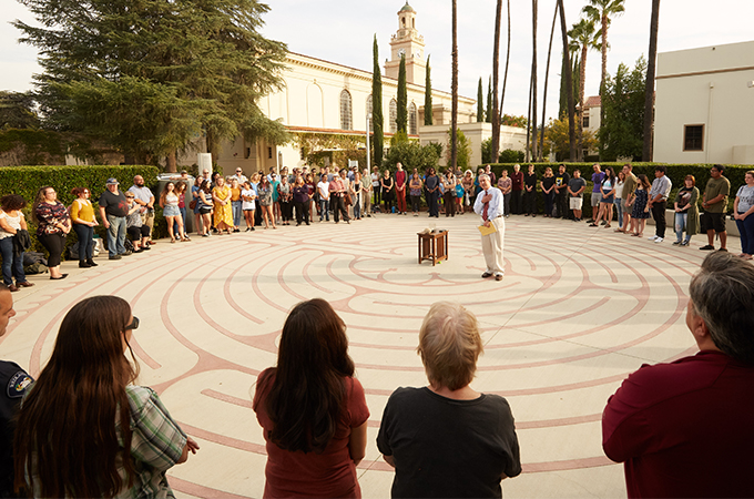 People stand in a circle around the labyrinth at the University of Redlands.