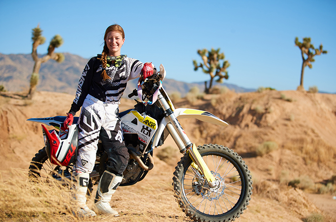 woman standing with a bmx bike