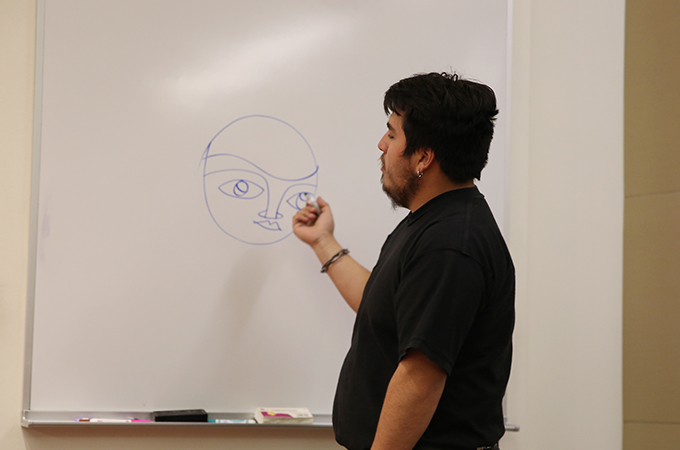 Camilo Díaz, an art student who paints with the Luchador Ernesto Miranda Muralists (UMLEM).