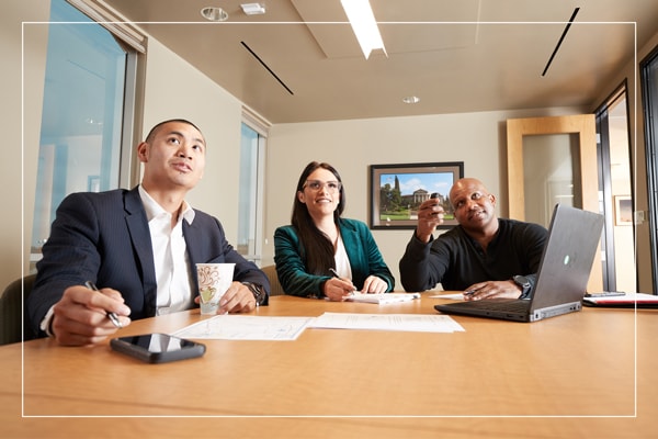 Group of people sitting around a conference table