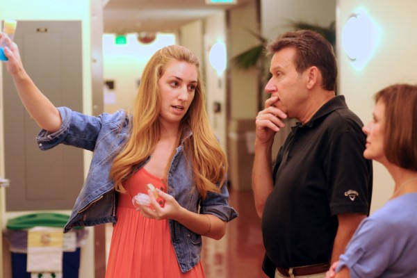 A student explains her poster to University President Dr. Ralph Kuncl.