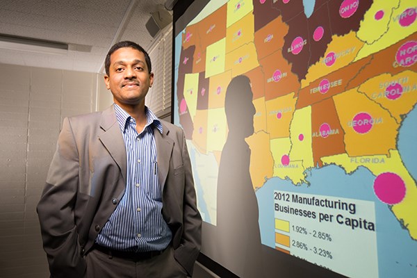 professor standing in front of a data map