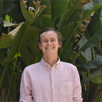 Student standing in front of quad and chapel